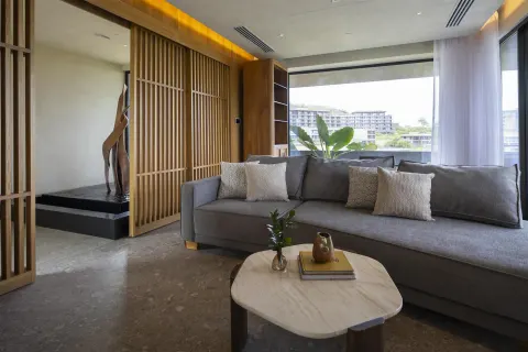 Presidential two-bedroom villa living room at Waldorf Astoria Costa Rica Punta Cacique with sofa and window.