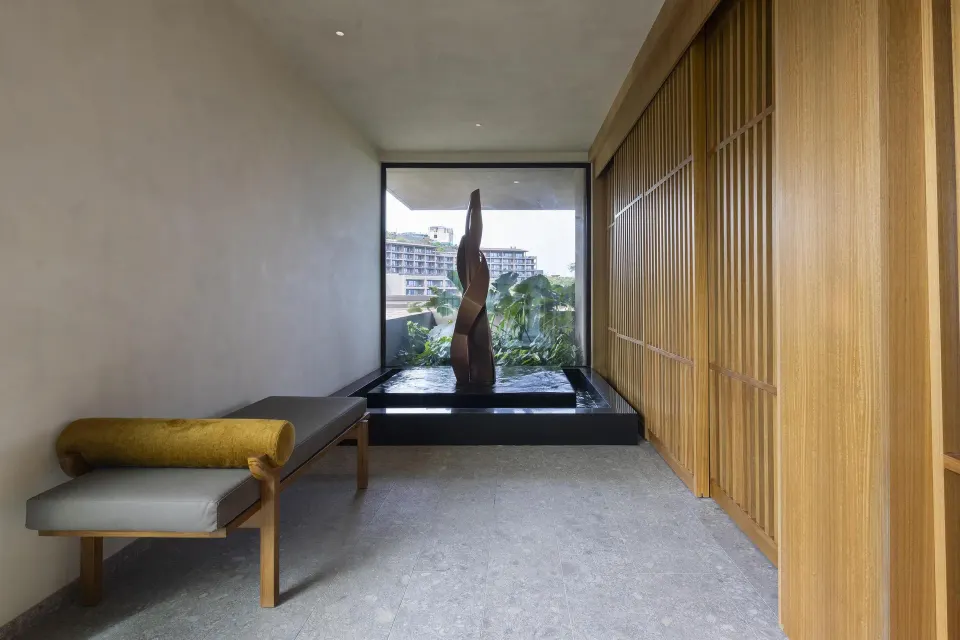 Villa corridor with sculpture and bench at Waldorf Astoria Costa Rica Punta Cacique.