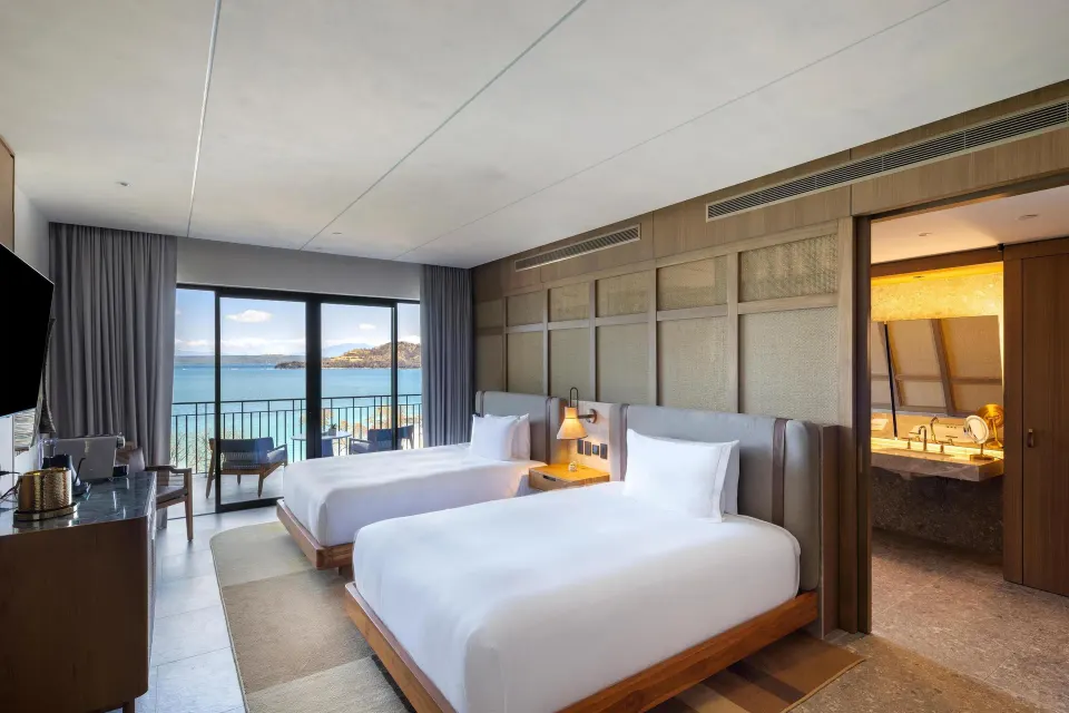Two queen beds and an ocean-facing balcony at Waldorf Astoria Costa Rica Punta Cacique.
