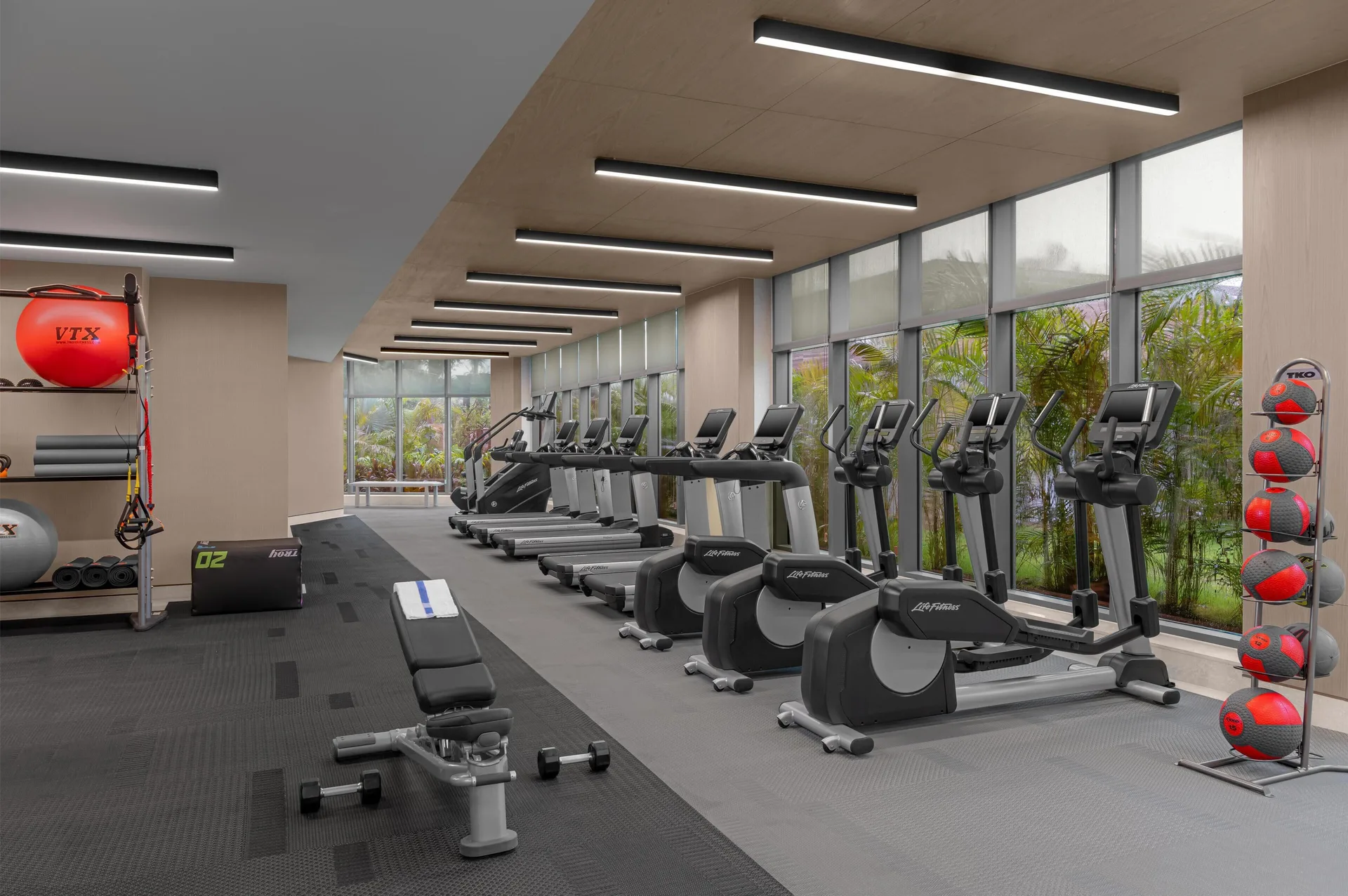 Fitness center with cardio machines and equipment at Waldorf Astoria Riviera Maya.
