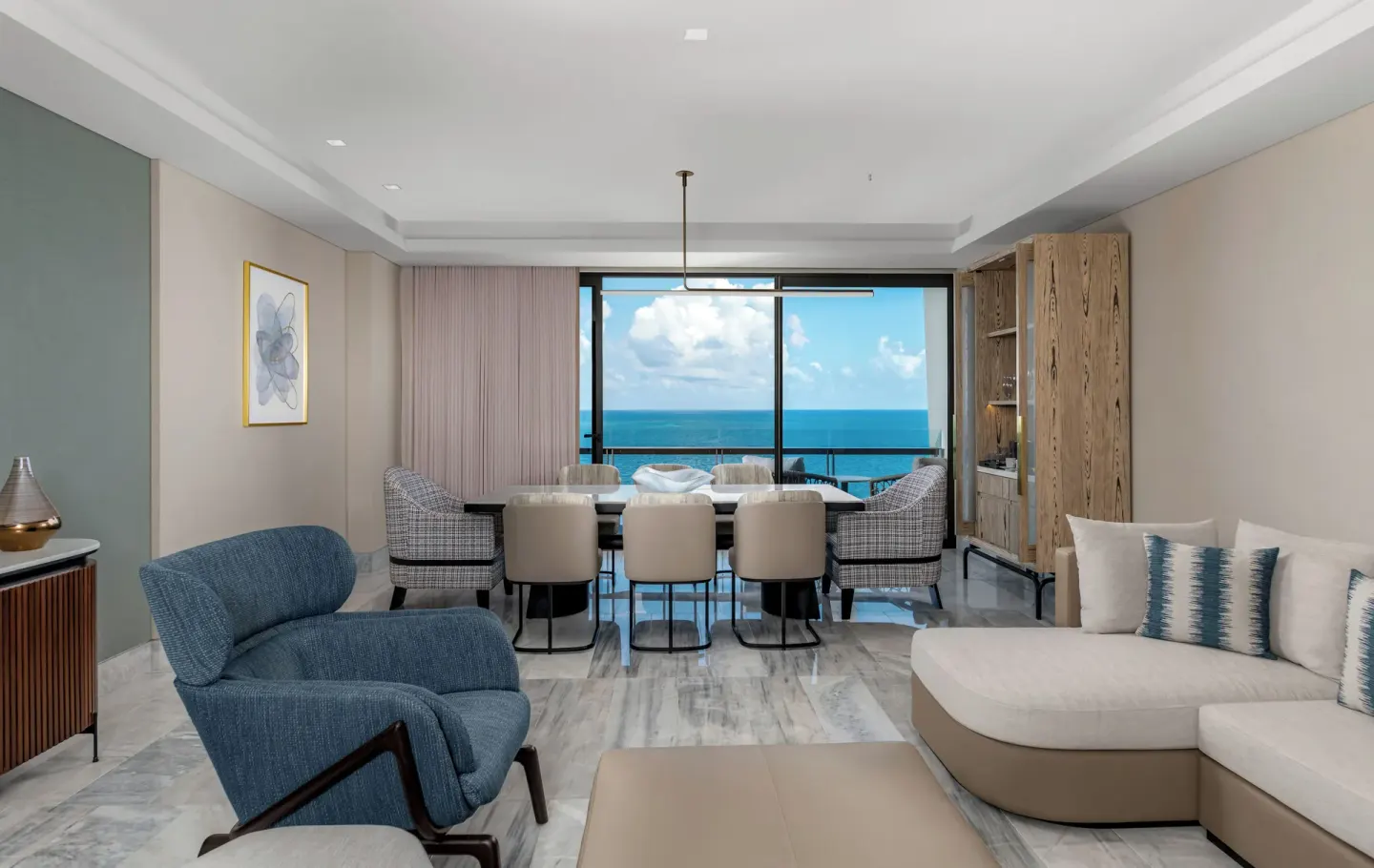 Ocean-view living and dining room in a suite at Waldorf Astoria Riviera Maya.