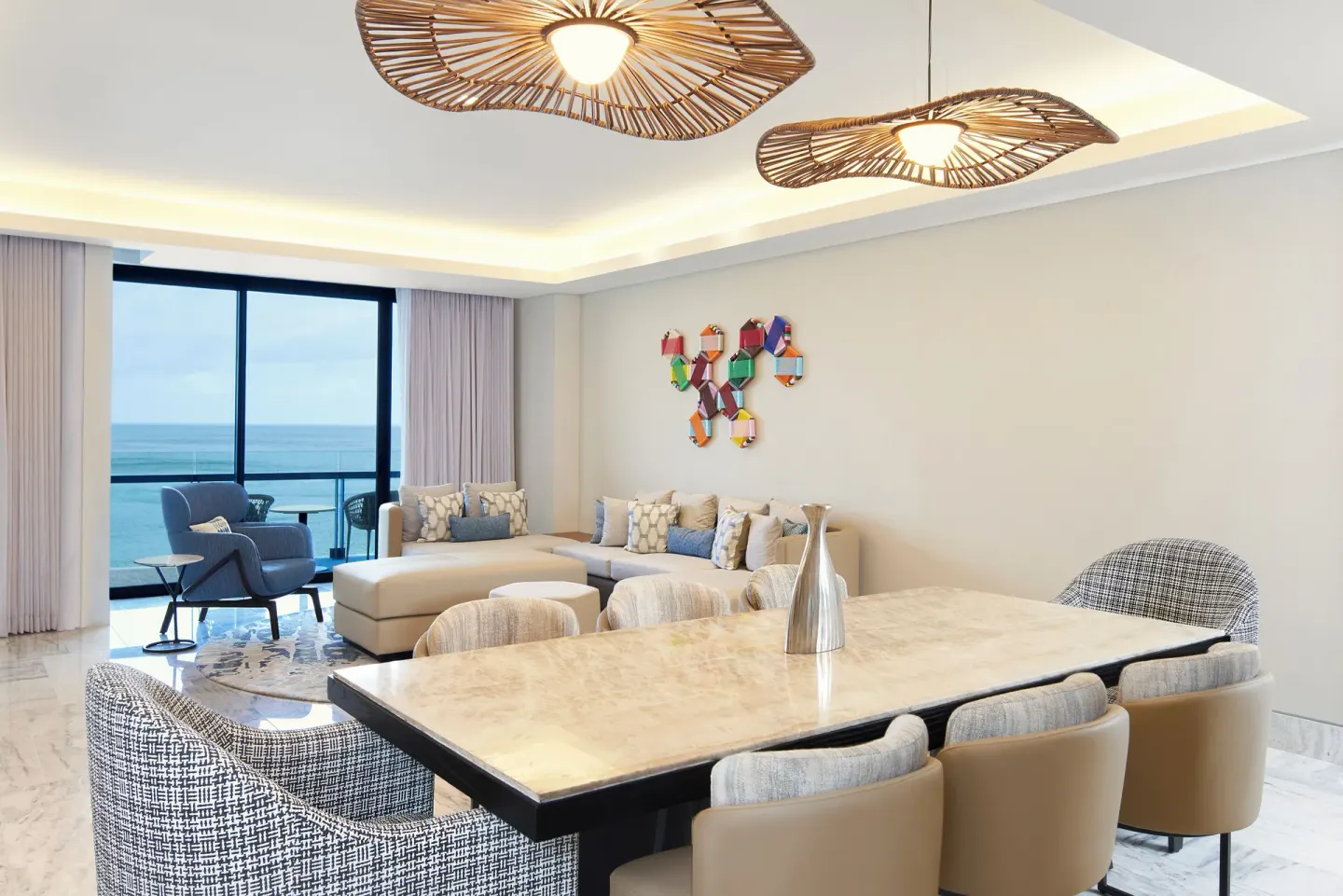 Ocean-view suite living and dining area at Waldorf Astoria Riviera Maya.