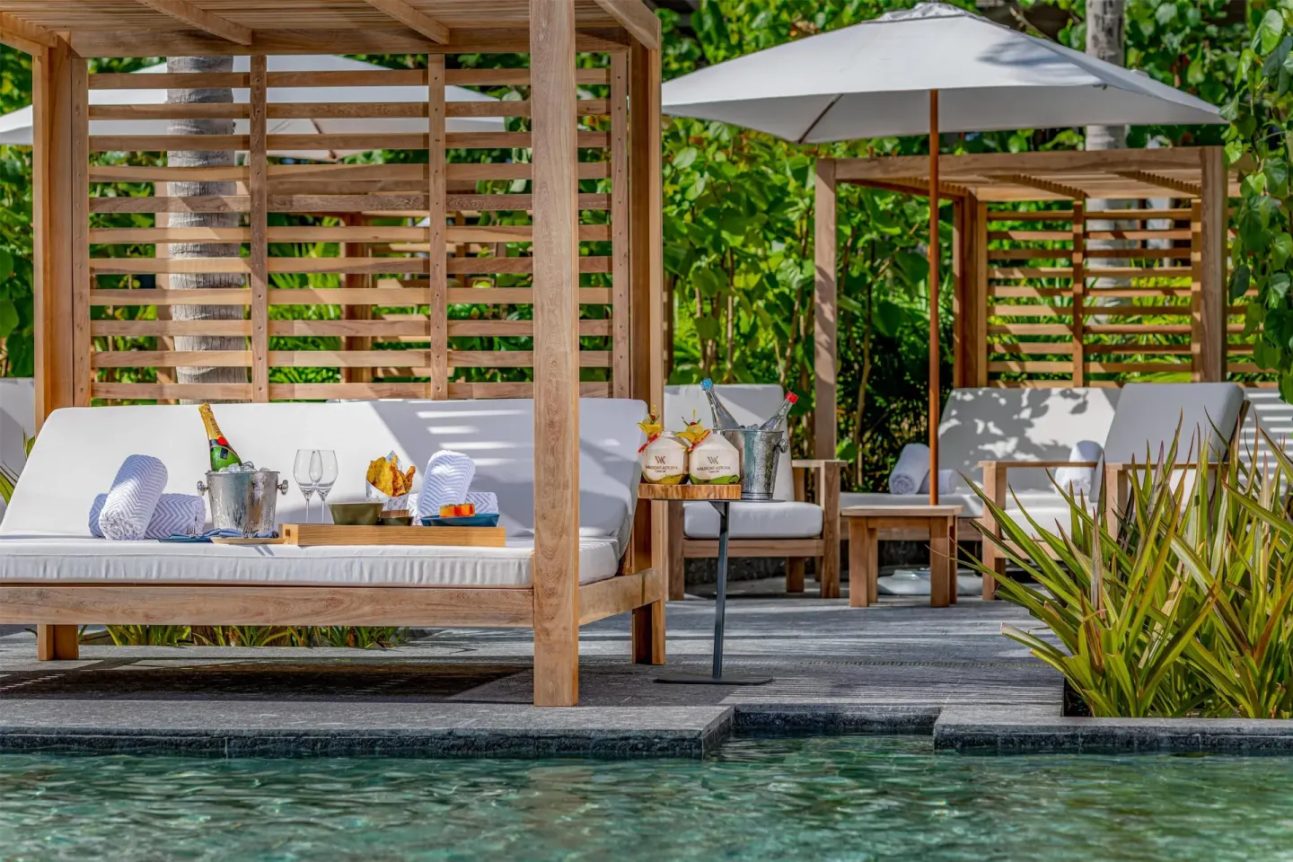 Poolside cabana with drinks and snacks at Waldorf Astoria Riviera Maya.
