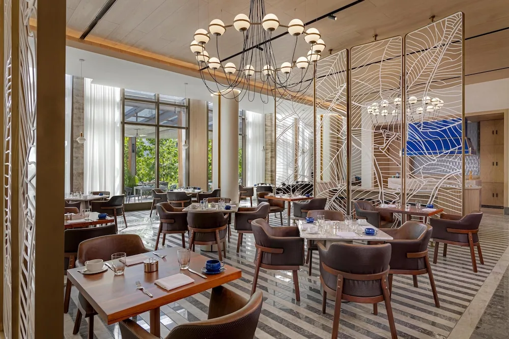 Elegant restaurant dining room with set tables at Waldorf Astoria Riviera Maya.