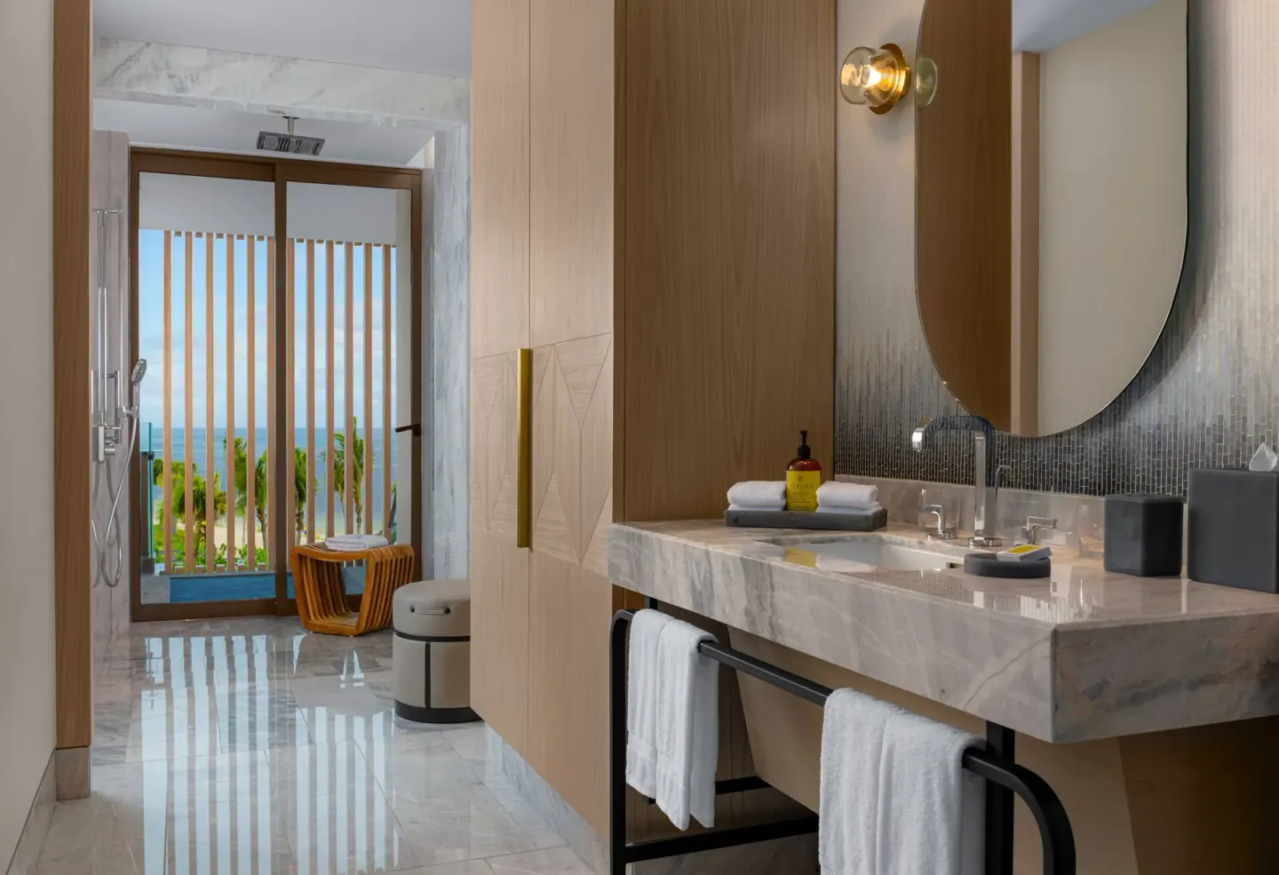 Accessible guest room bathroom vanity and shower area at Waldorf Astoria Riviera Maya.