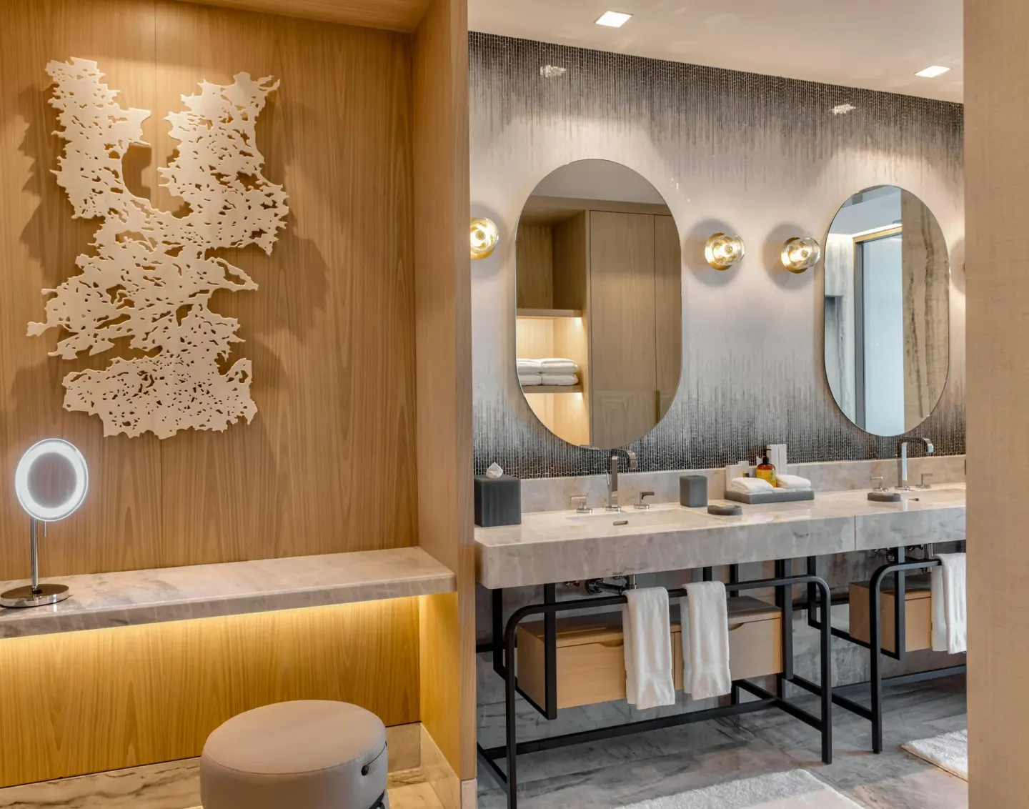 Double vanity bathroom with oval mirrors at Waldorf Astoria Riviera Maya.
