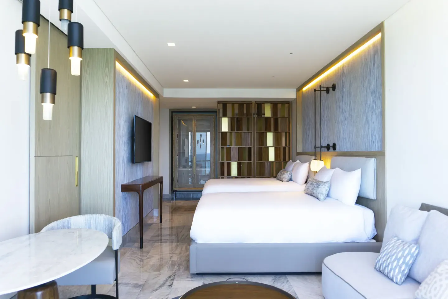 Deluxe Ocean View room with king bed and sitting area at Waldorf Astoria Riviera Maya.