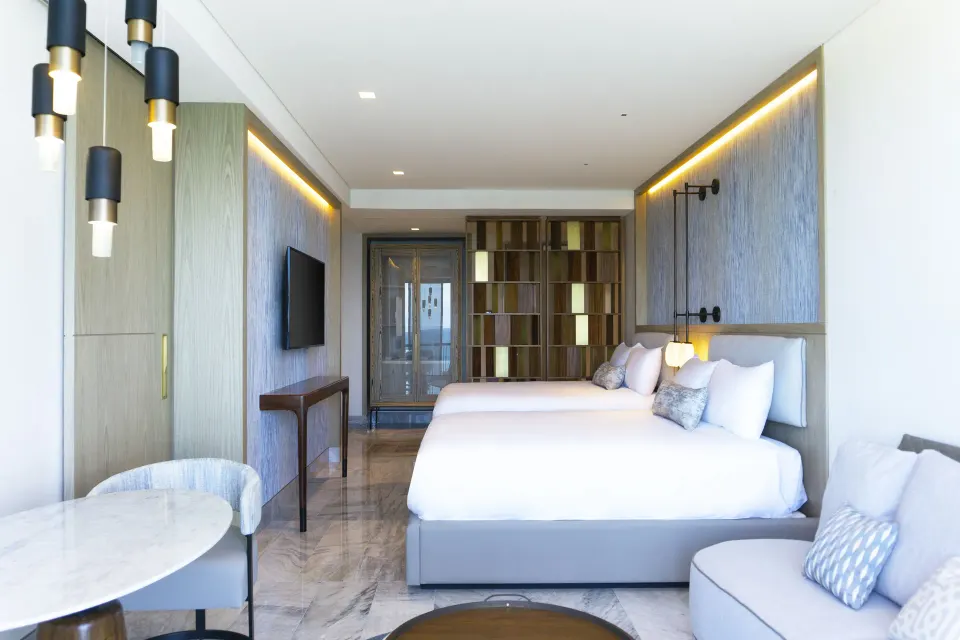 Deluxe Ocean View room with king bed and sitting area at Waldorf Astoria Riviera Maya.