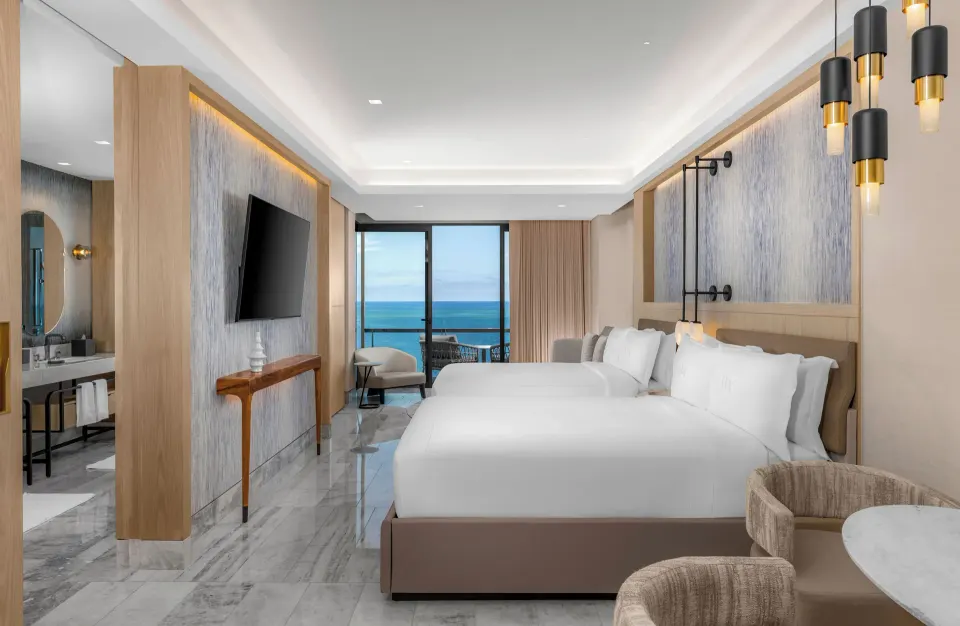 Deluxe Ocean View room with two beds and marble floor at Waldorf Astoria Riviera Maya.