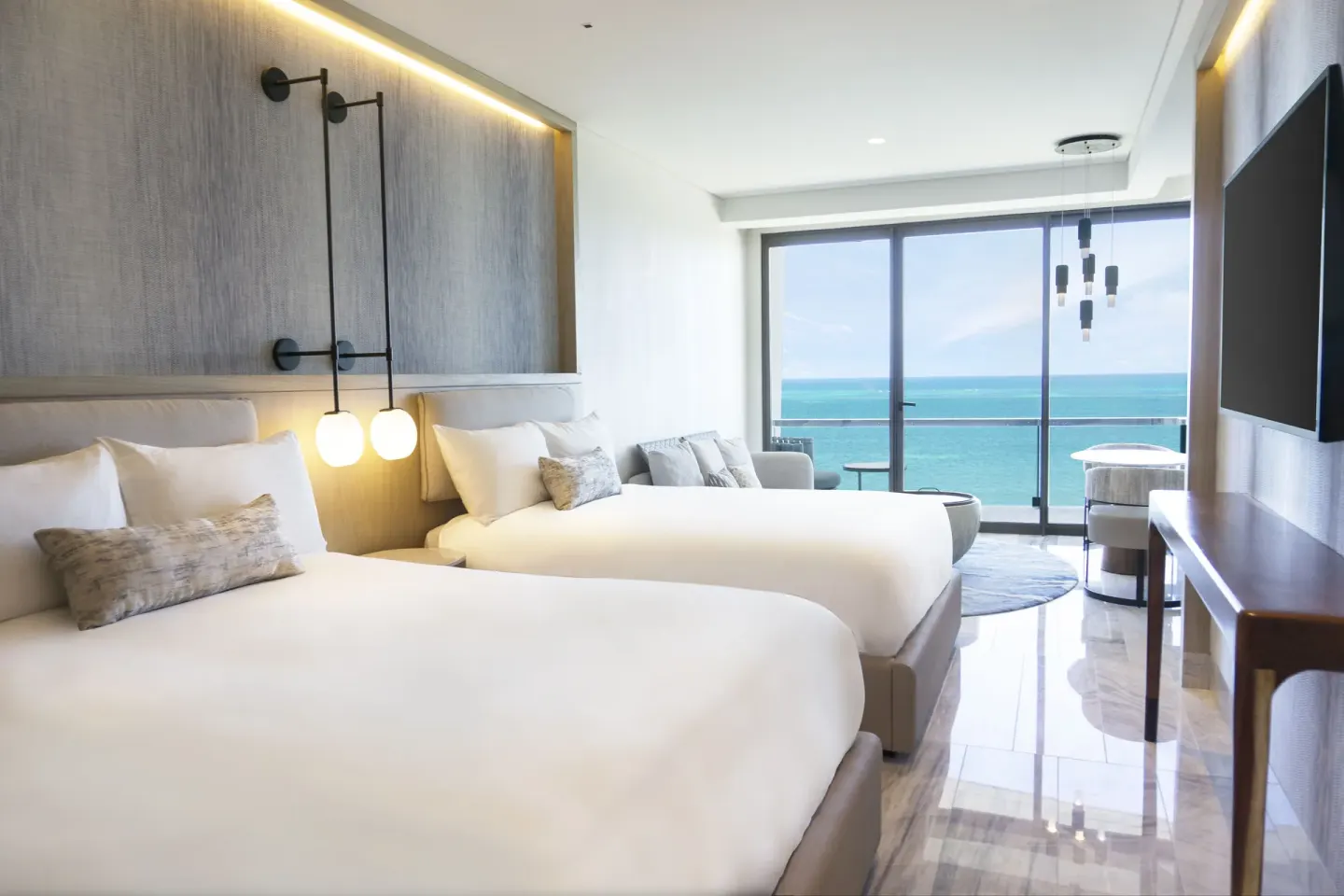 Deluxe Ocean View room with two beds and balcony at Waldorf Astoria Riviera Maya.