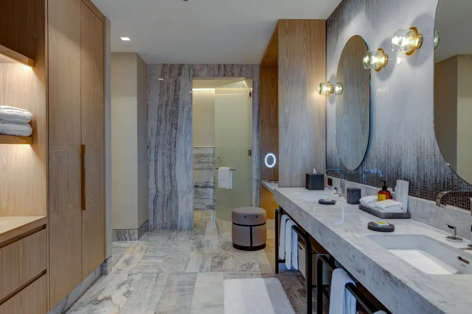 Deluxe Suite Ocean View marble bathroom with double vanity at Waldorf Astoria Riviera Maya.