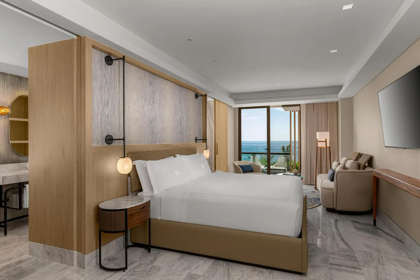 Presidential Suite king bed with balcony view at Waldorf Astoria Riviera Maya.
