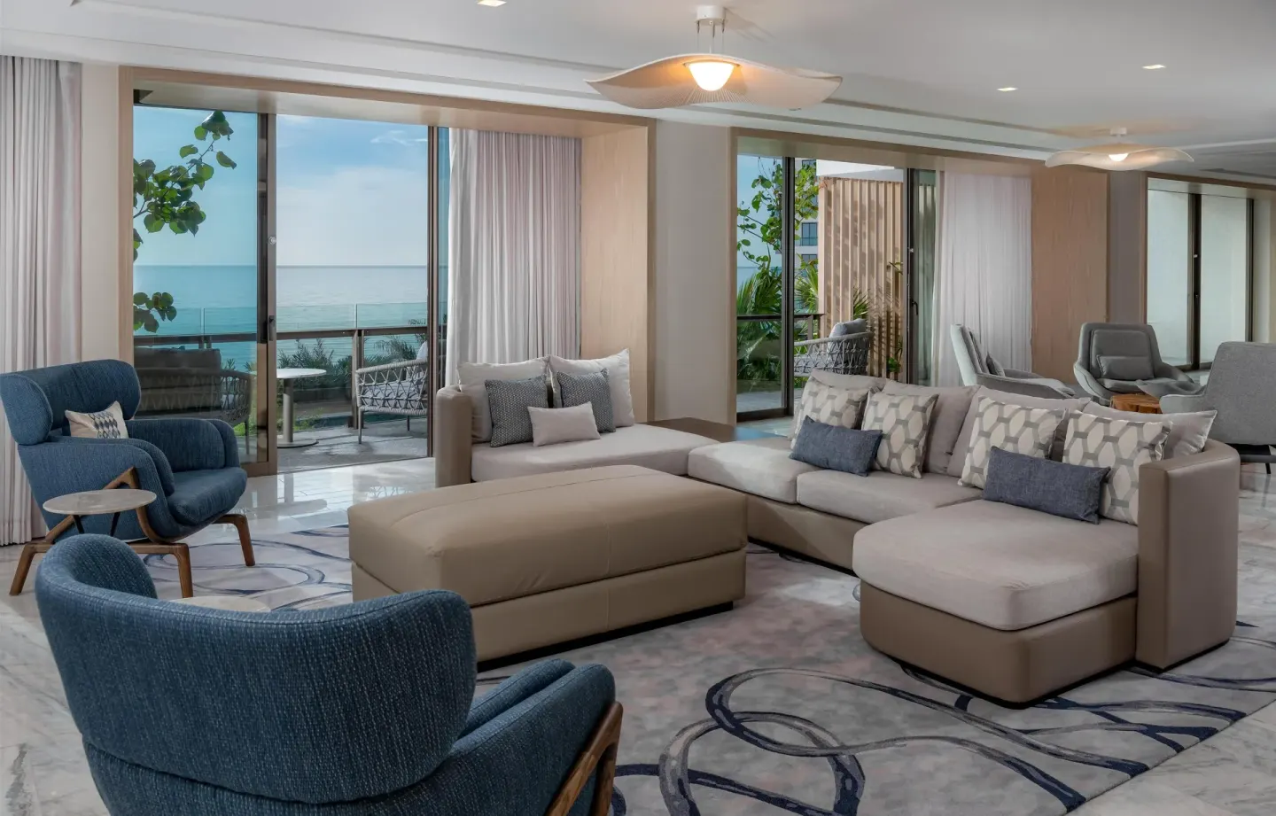 Presidential Suite living room with sectional sofa and ocean view at Waldorf Astoria Riviera Maya.