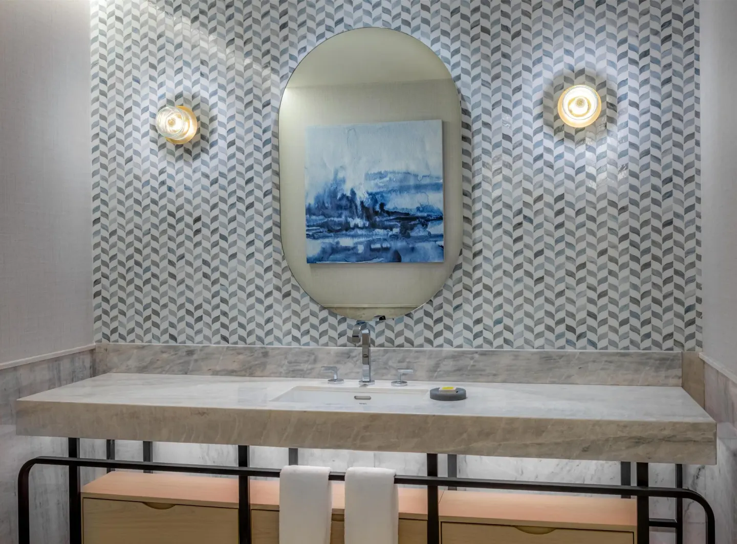 Marble accessible bathroom vanity with patterned wall at Waldorf Astoria Riviera Maya.