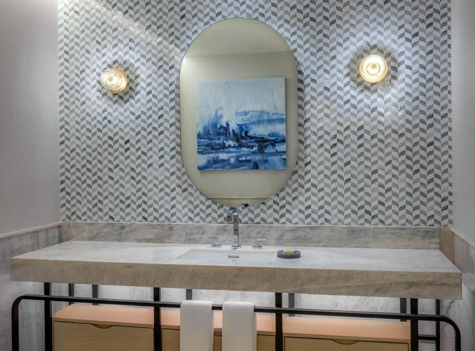Marble accessible bathroom vanity with patterned wall at Waldorf Astoria Riviera Maya.