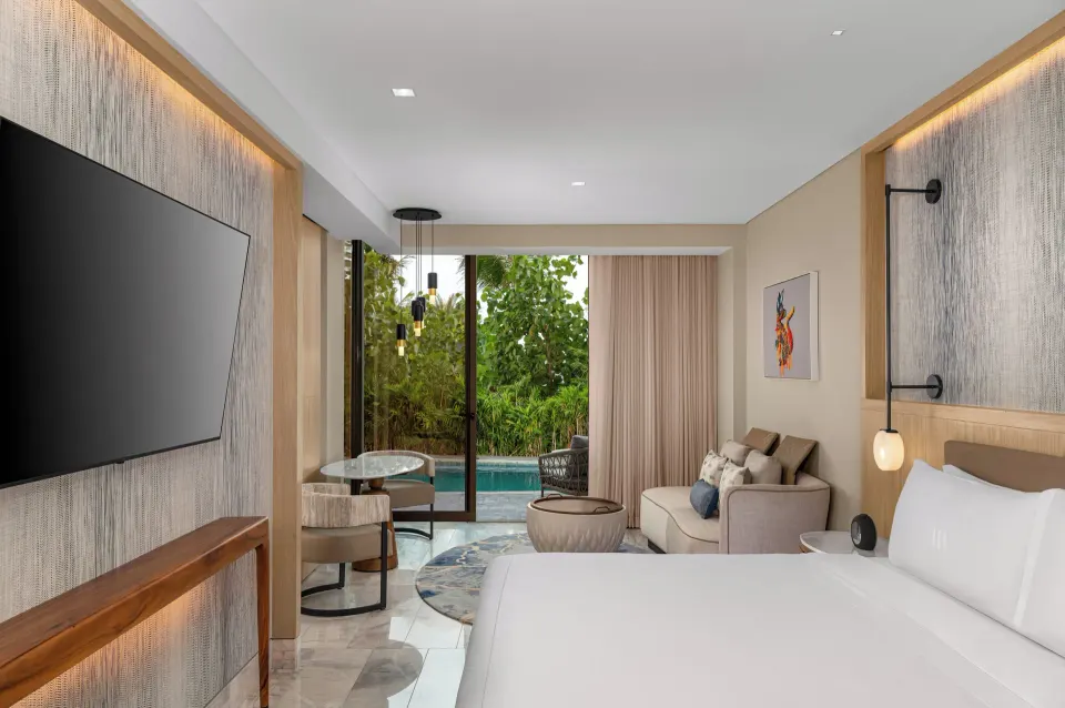 King swim-up guest room with sitting area and pool access at Waldorf Astoria Riviera Maya.