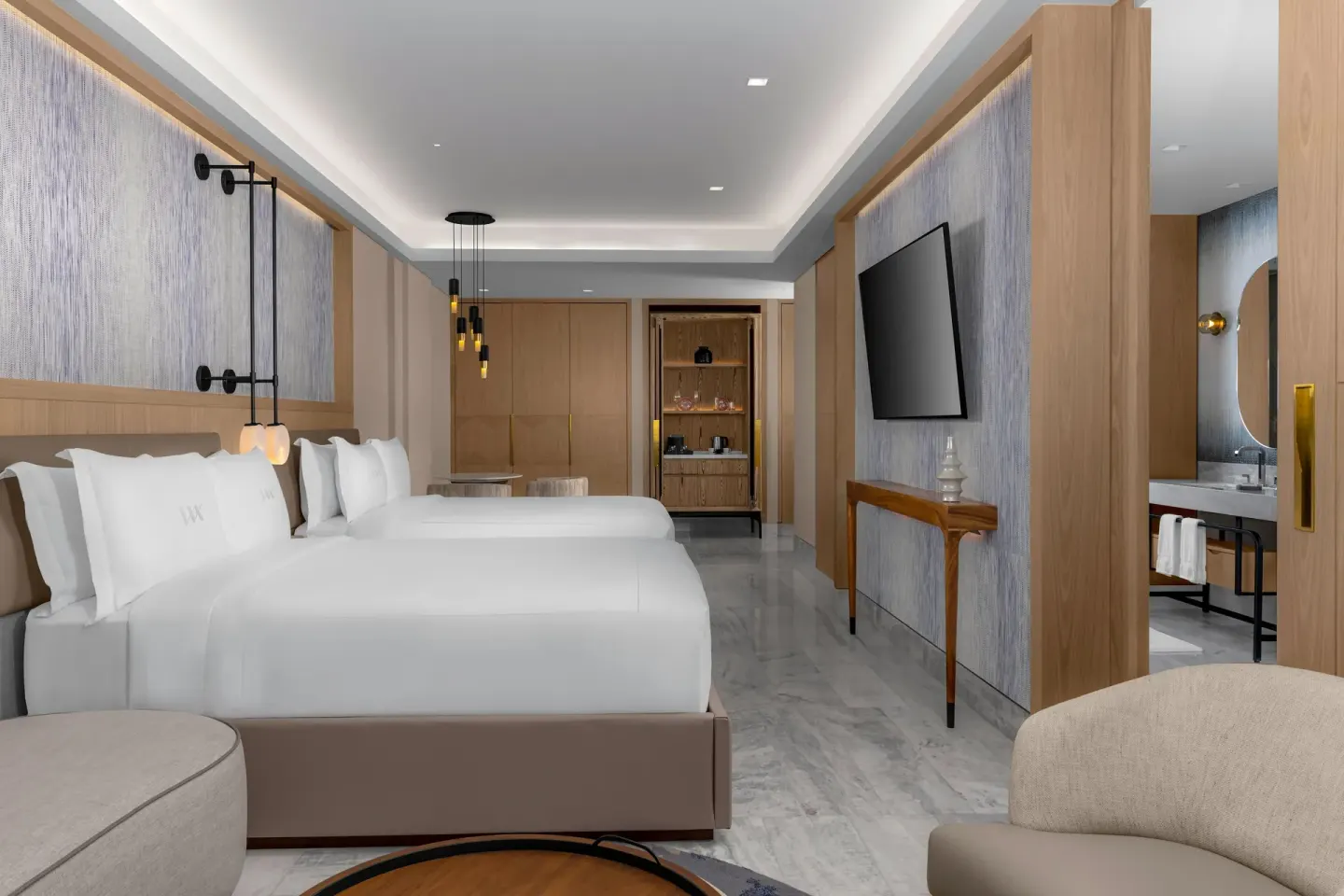 Two-bed swim-up guest room with seating and bath entry at Waldorf Astoria Riviera Maya.
