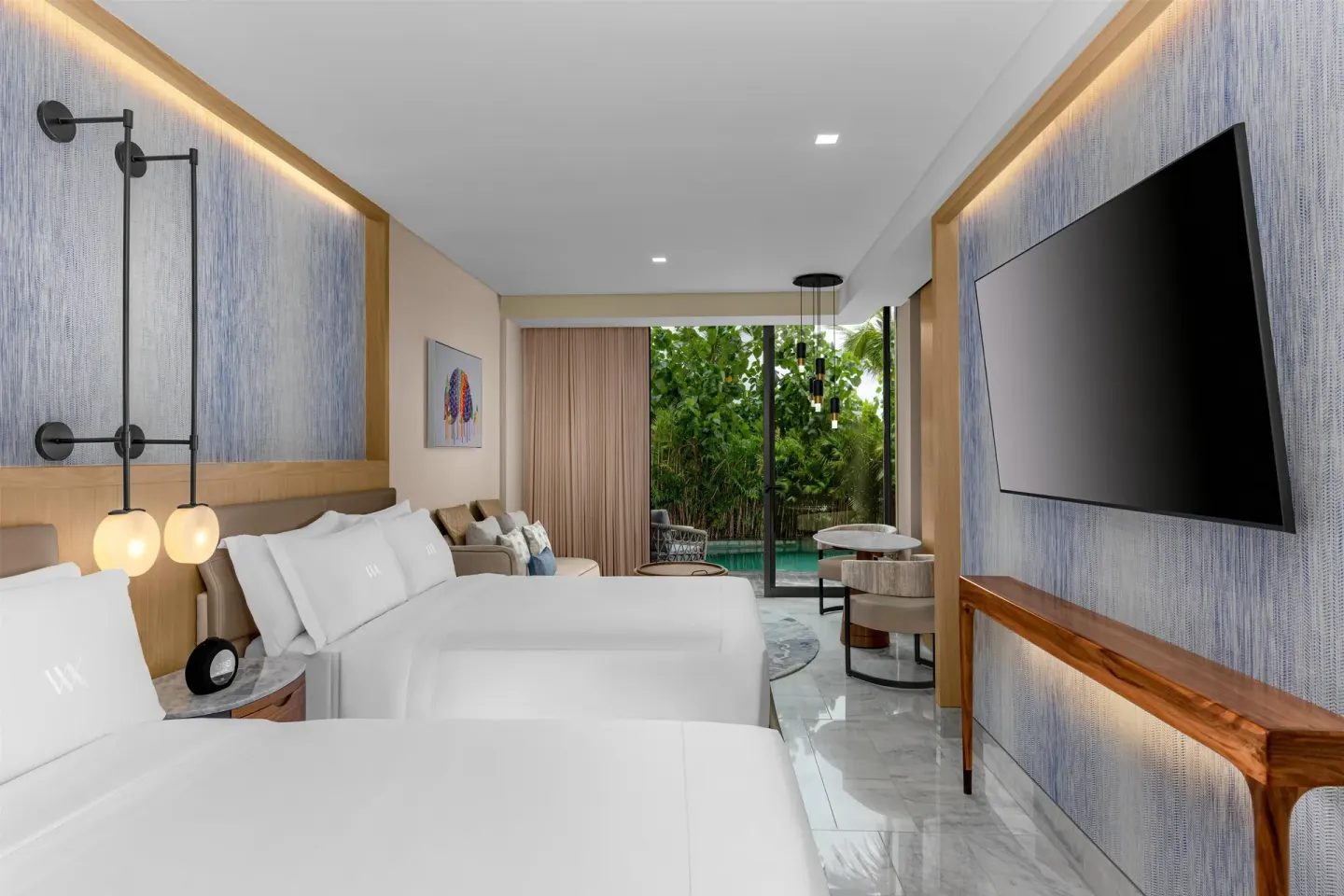 Two-bed swim-up guest room opening to a private pool at Waldorf Astoria Riviera Maya.