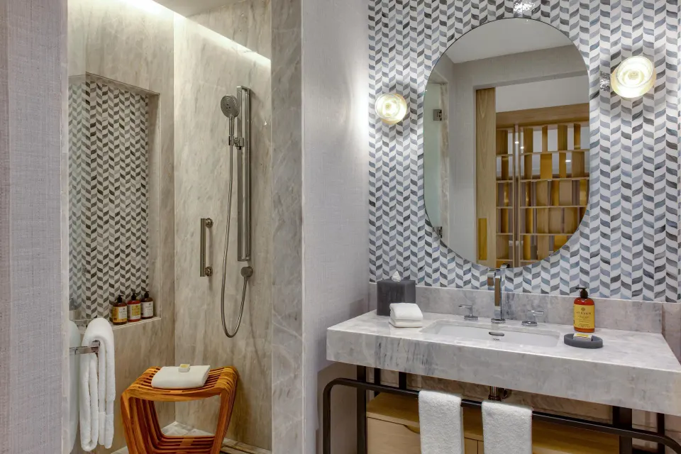 Bathroom vanity and walk-in shower in a Corner Ocean View Suite at Waldorf Astoria Riviera Maya.