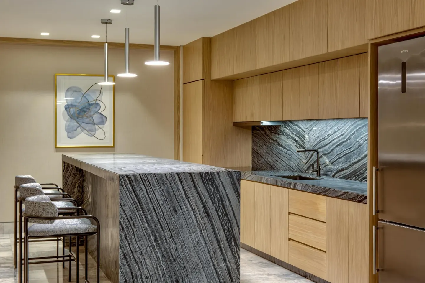 Corner ocean view suite kitchen with island and bar stools at Waldorf Astoria Riviera Maya.