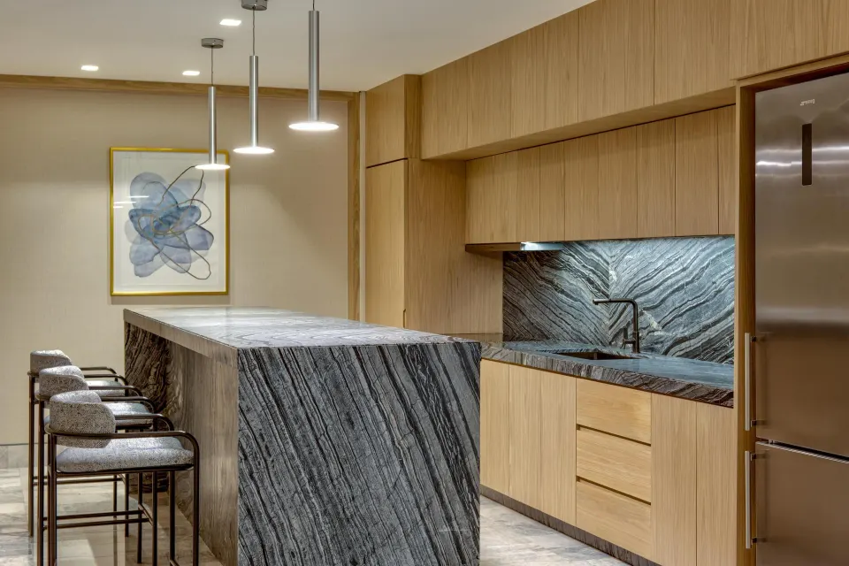 Corner ocean view suite kitchen with island and bar stools at Waldorf Astoria Riviera Maya.
