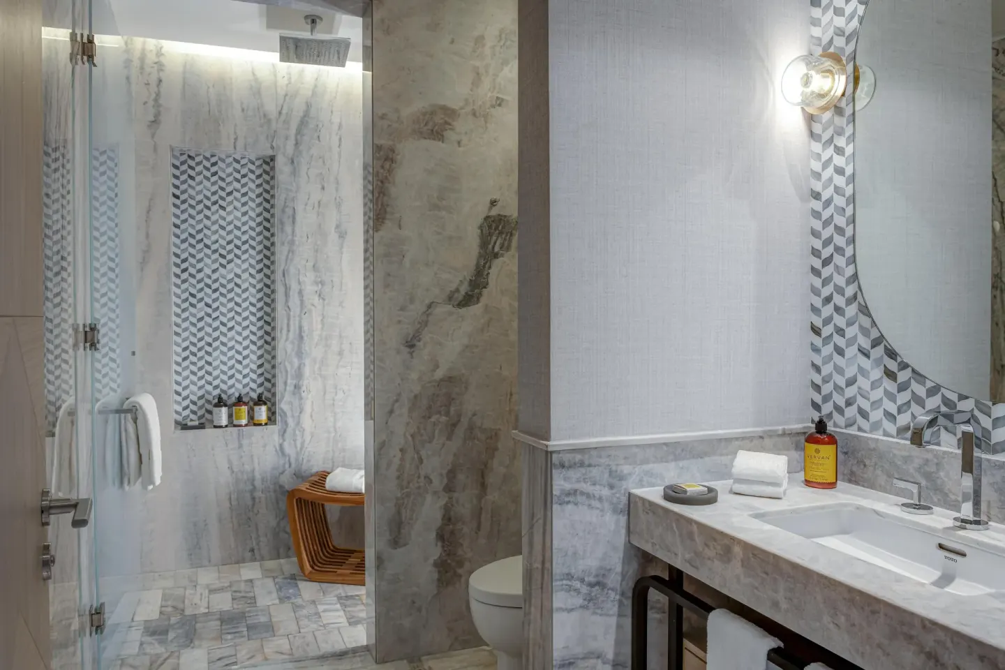 Oceanfront suite bathroom with shower and marble vanity at Waldorf Astoria Riviera Maya.