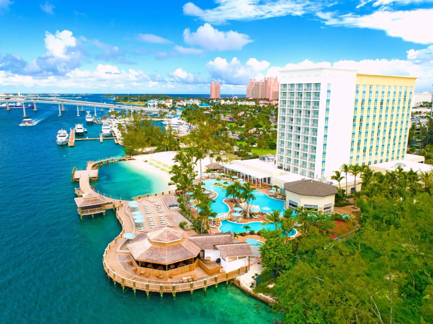 Aerial view of Warwick Paradise Island with tower, pools, beach and harbor.