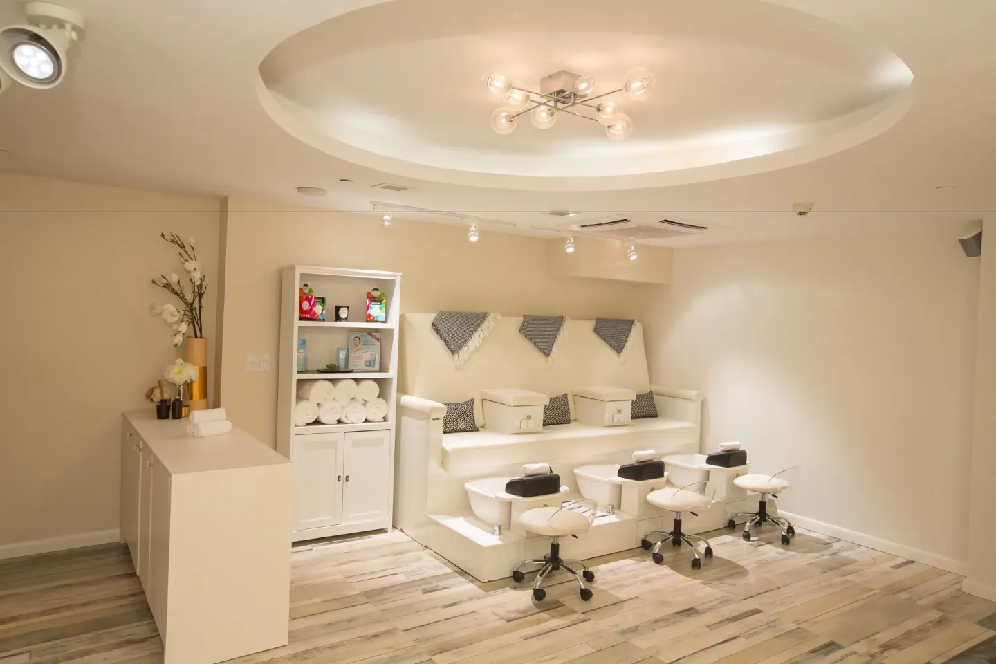 Pedicure chairs and stools in a white spa salon at Warwick Paradise Island.