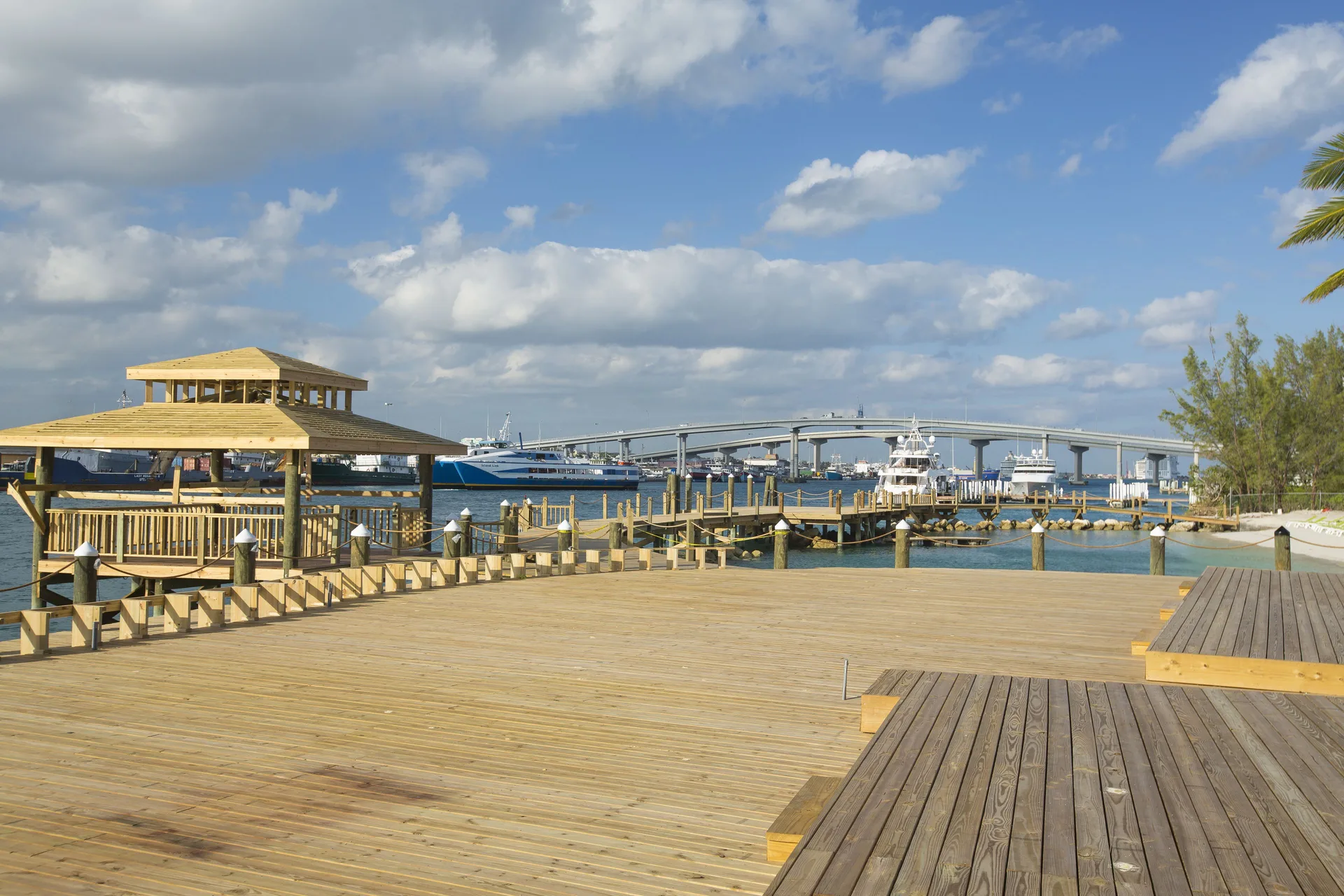 A wooden waterfront deck and gazebo overlook the marina at Warwick Paradise Island.