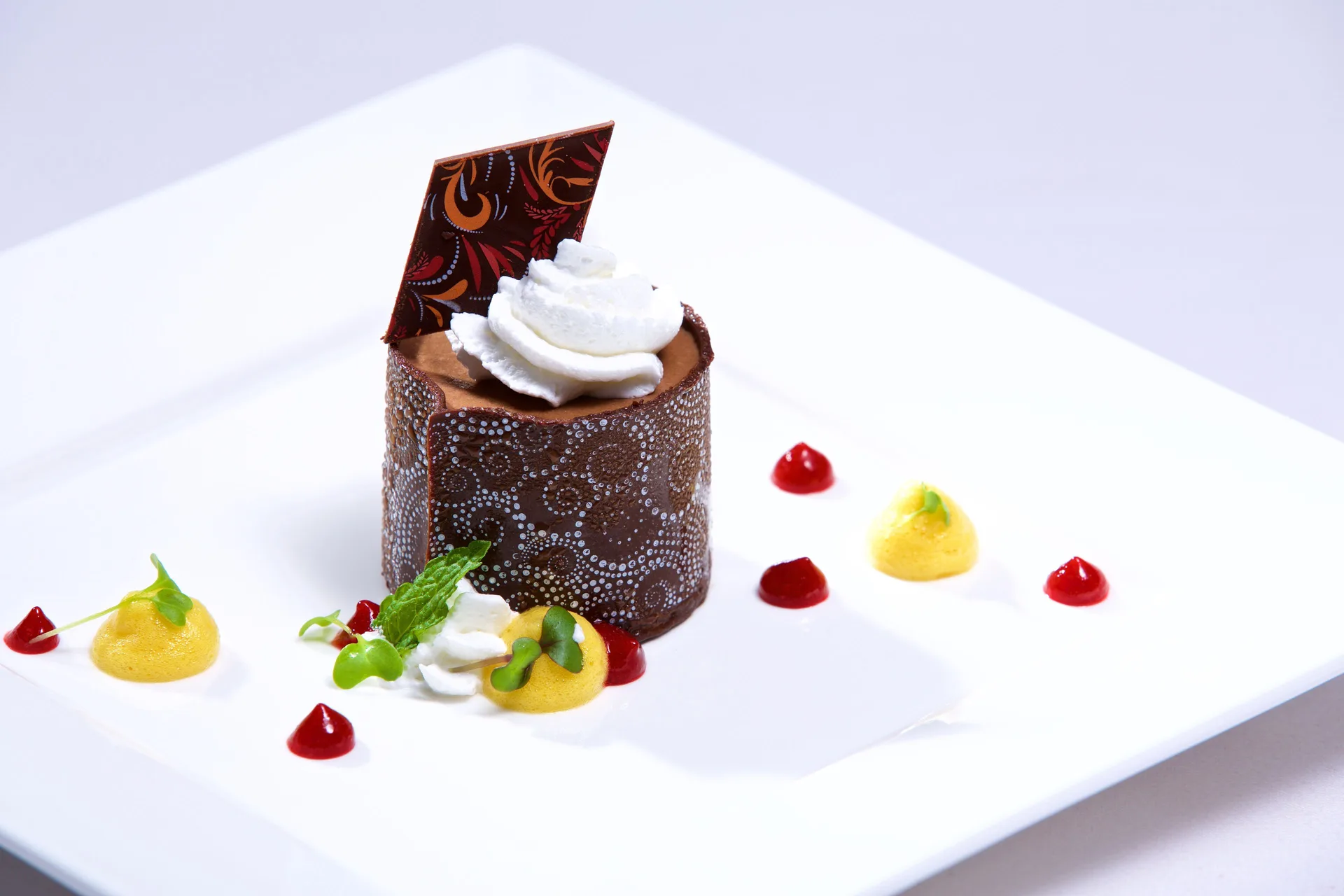 Chocolate dessert with whipped cream and fruit sauces at Warwick Paradise Island.