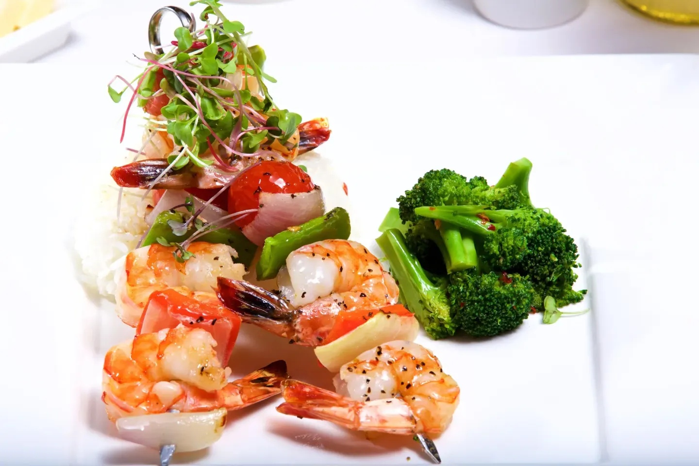 Grilled shrimp skewers with rice and broccoli at Warwick Paradise Island.