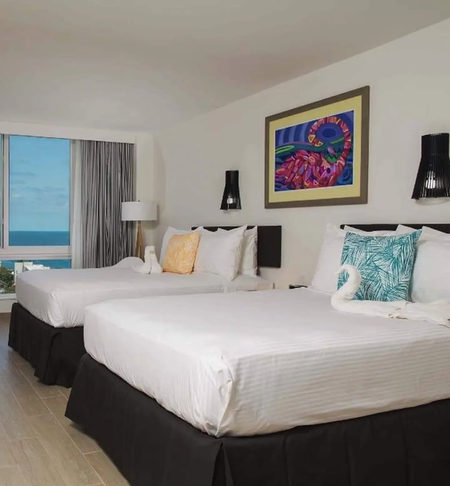 Island View guest room with two beds and ocean-facing window at Warwick Paradise Island.