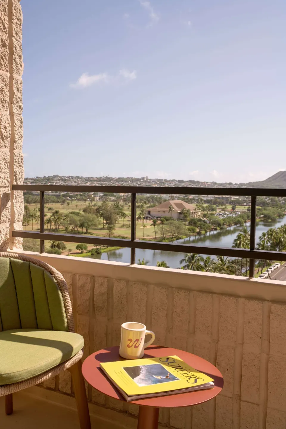 Balcony chair and table overlooking the canal at Wayfinder Waikiki.