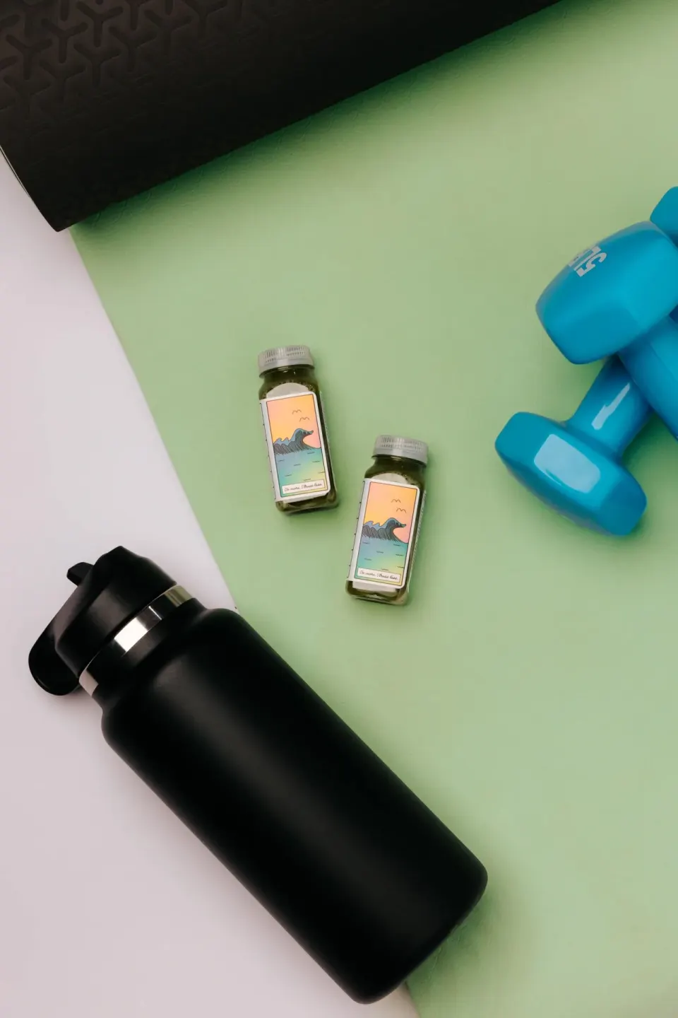 Yoga mat, dumbbells, water bottle, and small bottles at Wayfinder Waikiki.