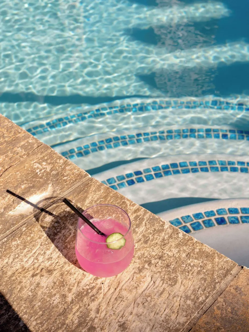 Pink cocktail on the pool edge at Wayfinder Waikiki.