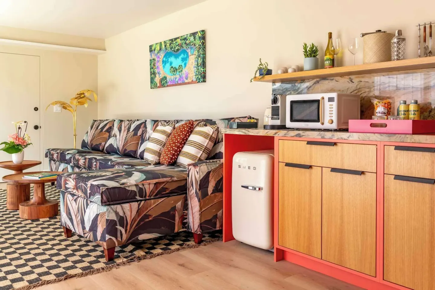 Suite living area with sofa and kitchenette at Wayfinder Waikiki.