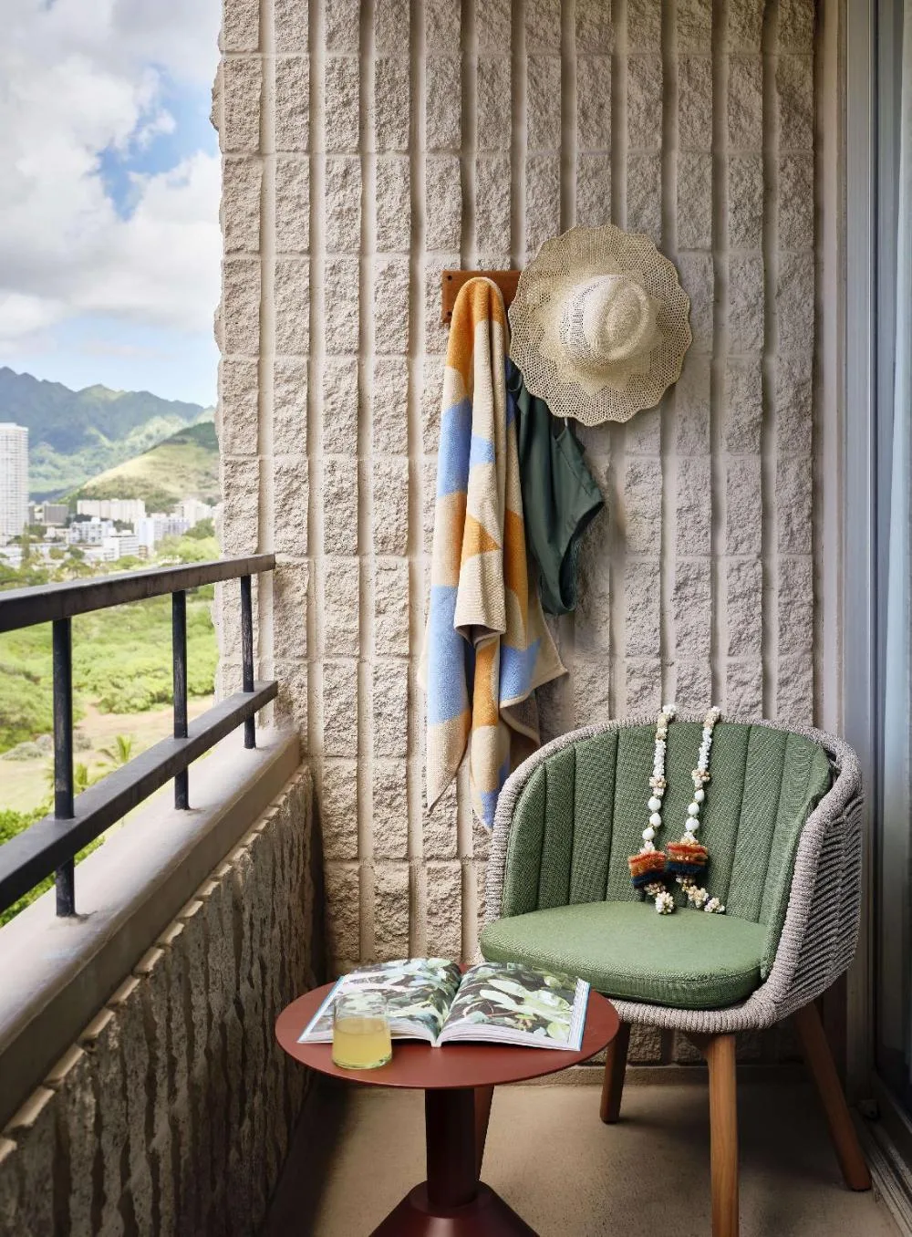 Accessible Bed with Lanai balcony at Wayfinder Waikiki with chair, small table, and mountain view.