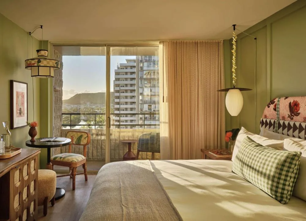 Accessible Bed with Lanai guest room at Wayfinder Waikiki with bed, desk seating, and balcony doors.