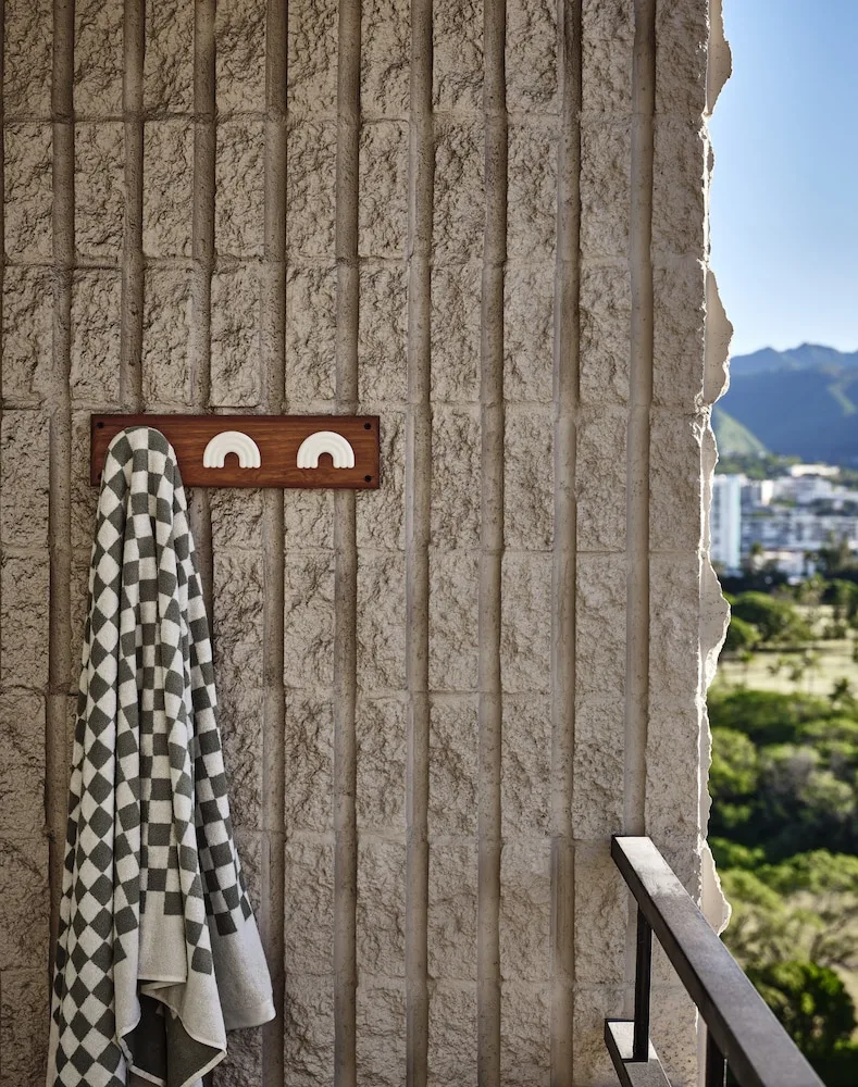 Lanai balcony wall with towel hooks and mountain view at Wayfinder Waikiki.