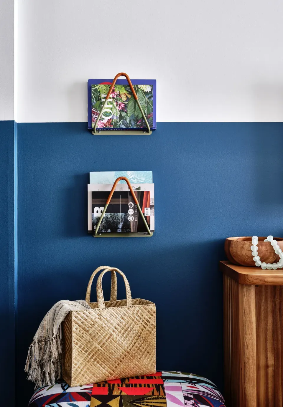 Premium Room wall shelves with magazines and woven tote at Wayfinder Waikiki.