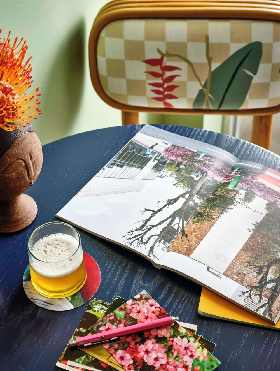 Premium Room table detail with drink, notebook, and chair at Wayfinder Waikiki.