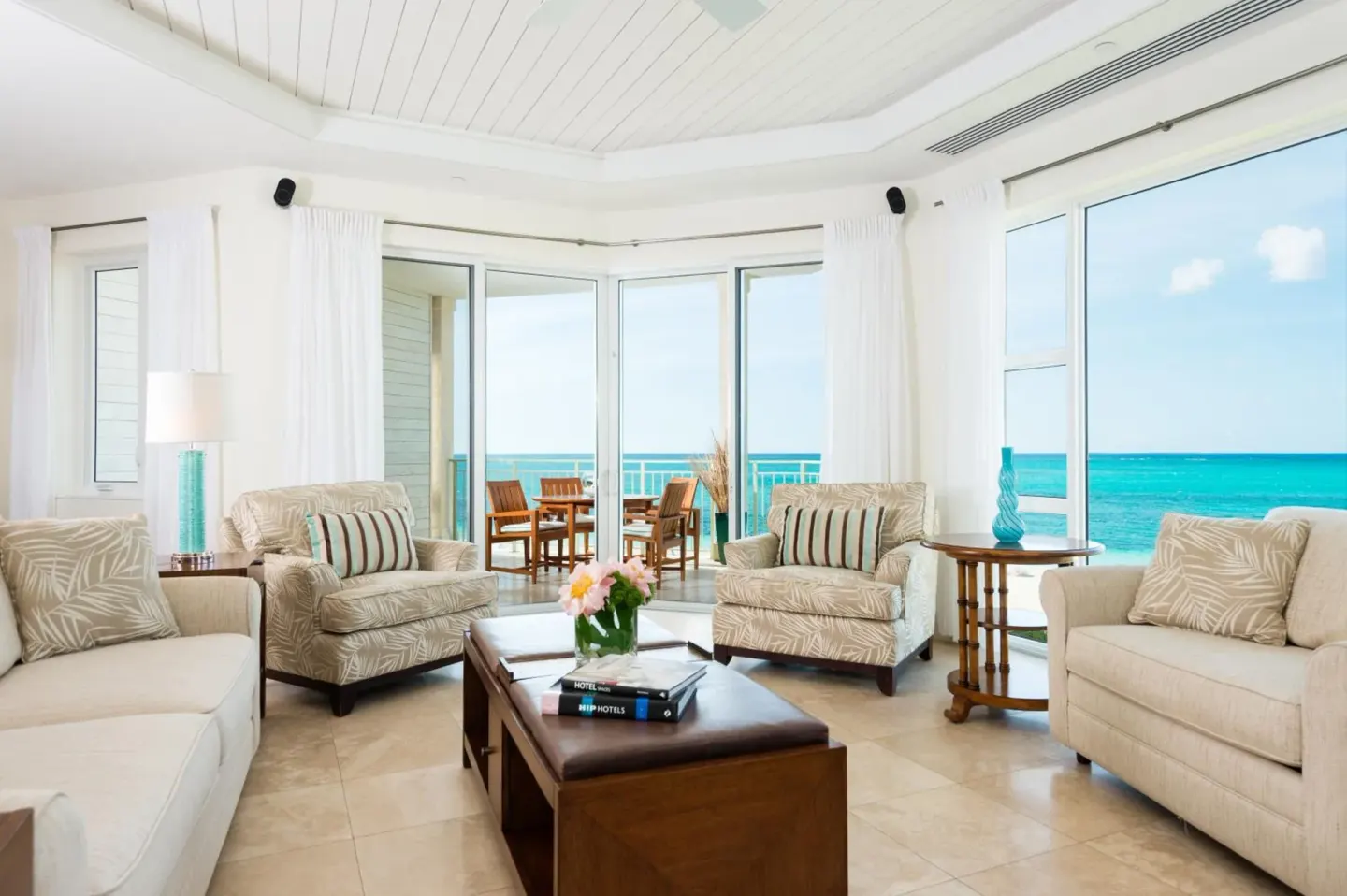 Ocean-view living room with sofas and balcony doors at West Bay Club.