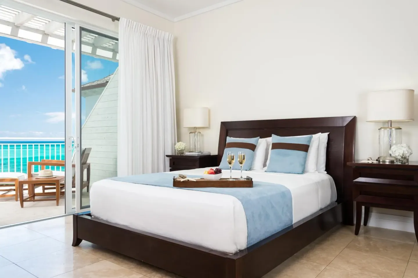 King bedroom with balcony and ocean view at West Bay Club.