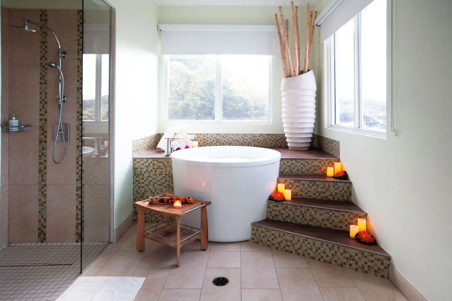 Bathroom with soaking tub, glass shower and candles at Windjammer Landing Resort and Residences.