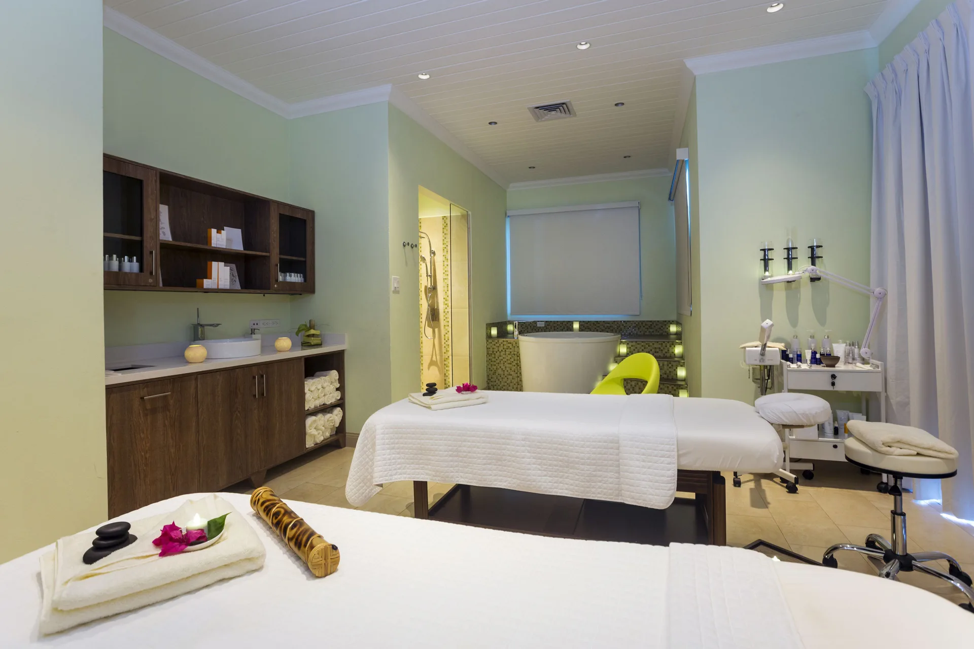 A couples spa treatment room with two massage tables at Windjammer Landing Resort and Residences.
