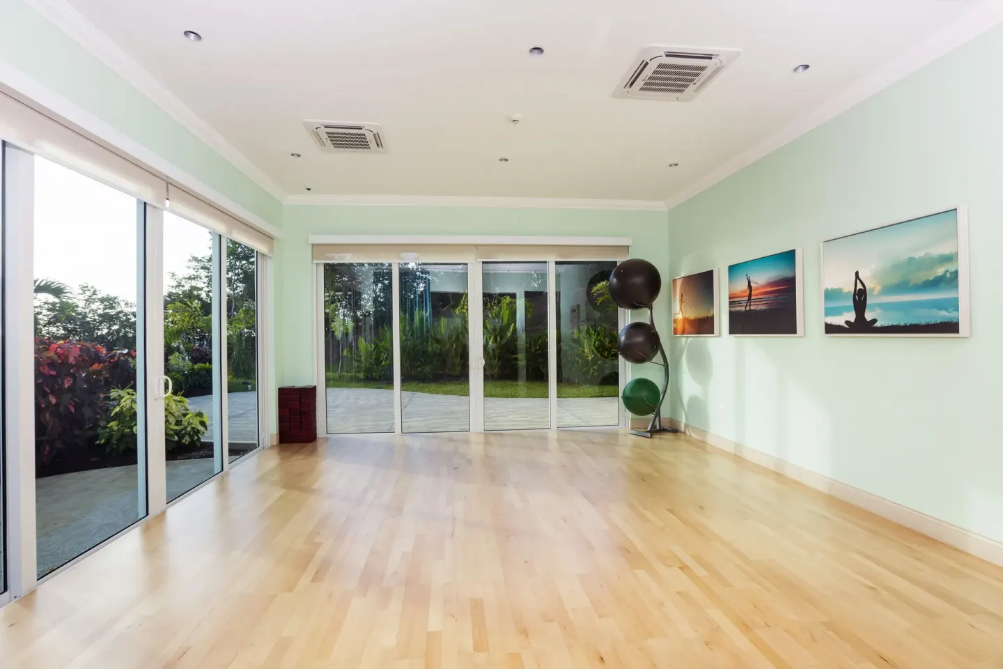 Exercise studio with wood floor, garden doors, and stability balls at Windjammer Landing Resort and Residences.