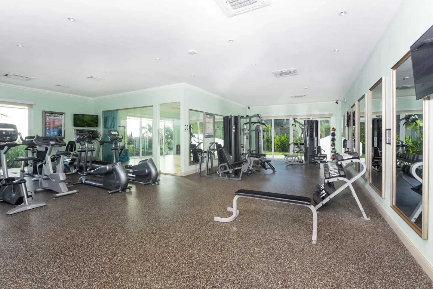 Fitness center with cardio machines and weight equipment at Windjammer Landing Resort and Residences.