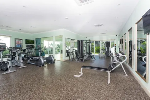 Fitness center with cardio machines and weight equipment at Windjammer Landing Resort and Residences.