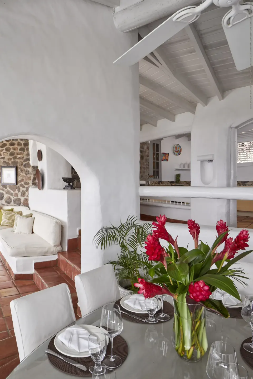 Guest suite dining table with red flowers at Windjammer Landing Resort and Residences.