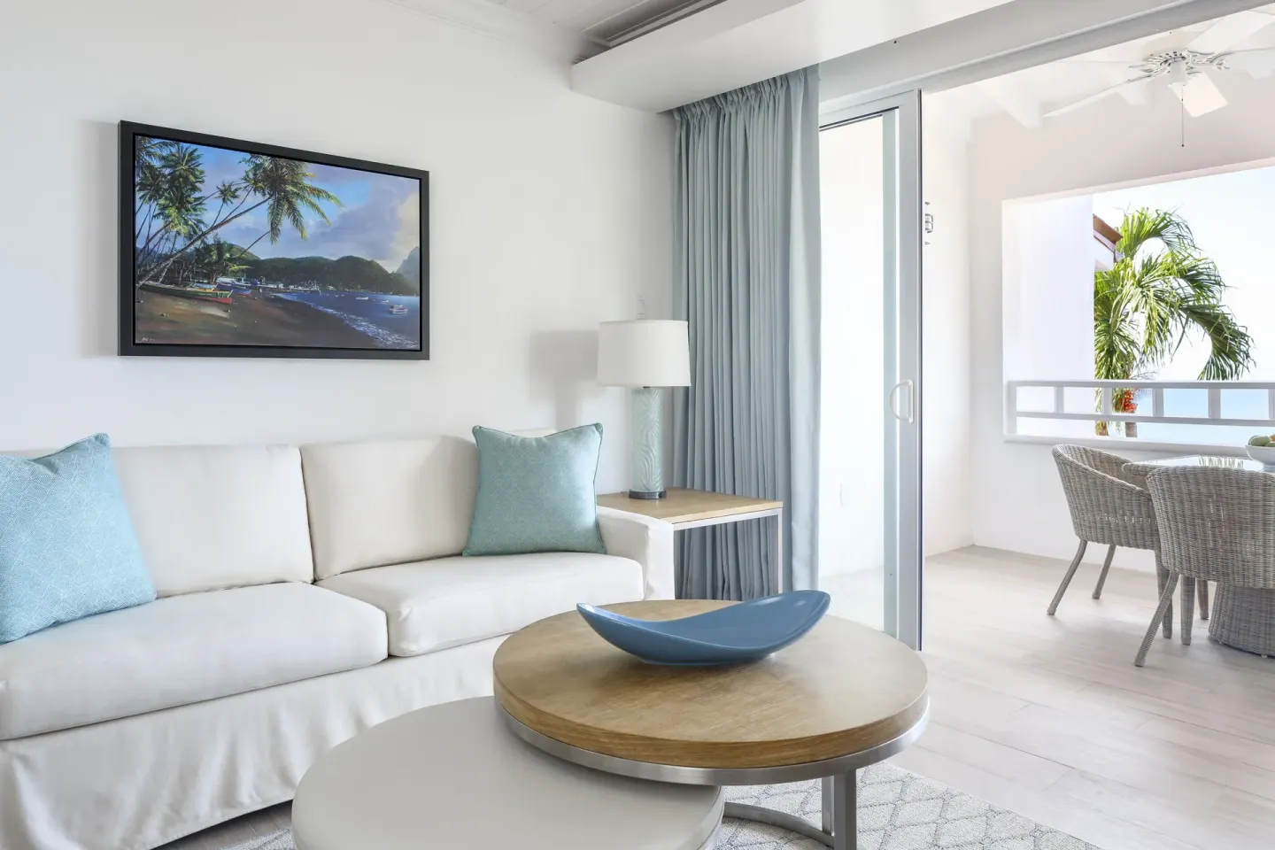 Guest suite living room opening to a balcony at Windjammer Landing Resort and Residences.